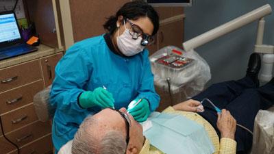 Dental Hygiene student working with a patient